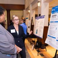Shannon (right) presenting to a guest at the 2023 Graduate Showcase.